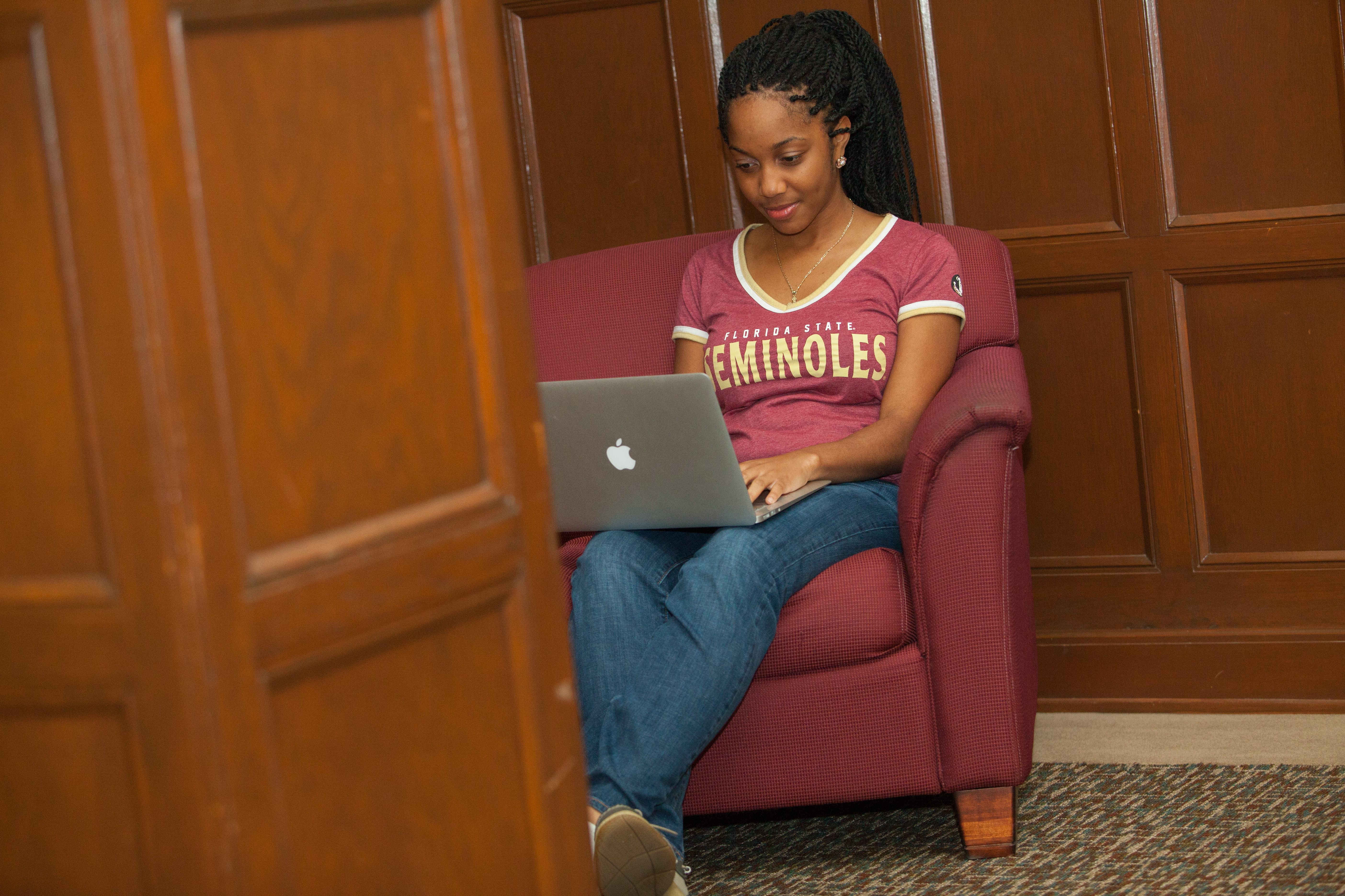 An FSU student working on their laptop. 